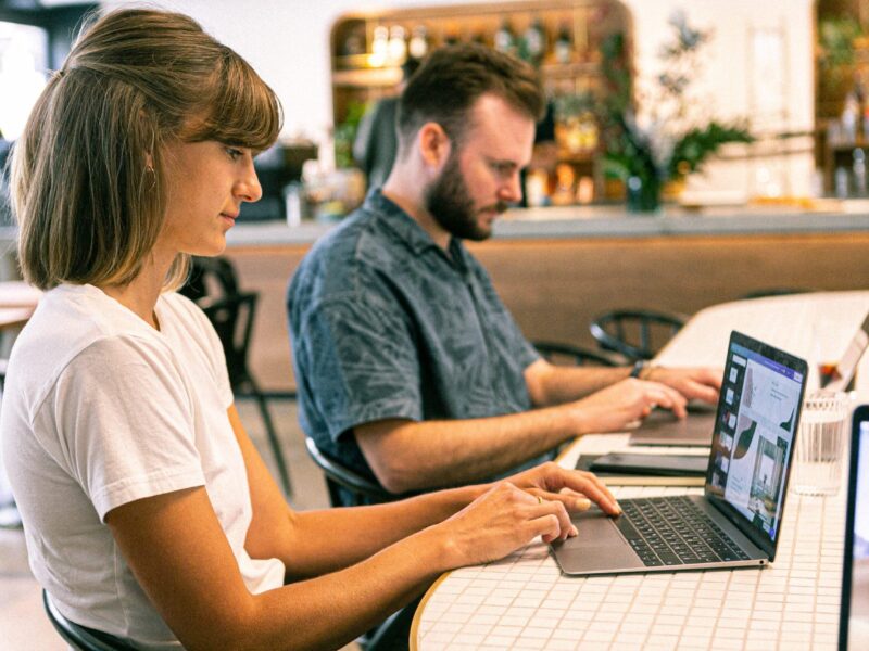 Woman and man using laptop