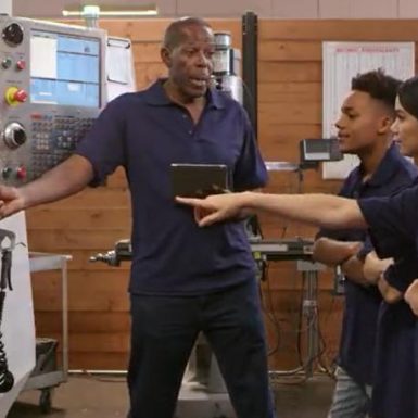 Apprentices being shown how a machine works