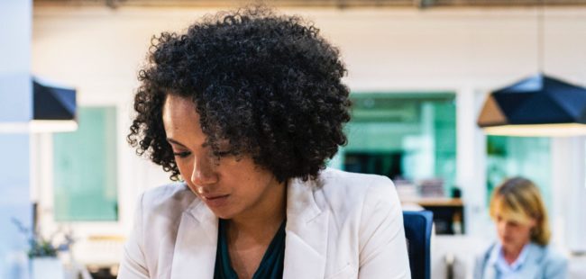 A business woman checks her phone