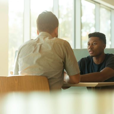 Two people in a booth talking