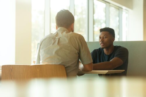 Two people in a booth talking