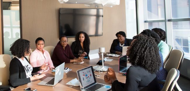 A meeting featuring women of colour