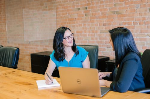 Two women evaluating performance