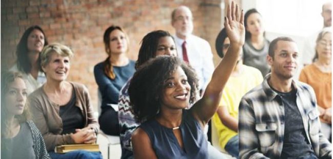 Inspiring Apprenticeships: A group of people in a classroom raising hands and asking questions