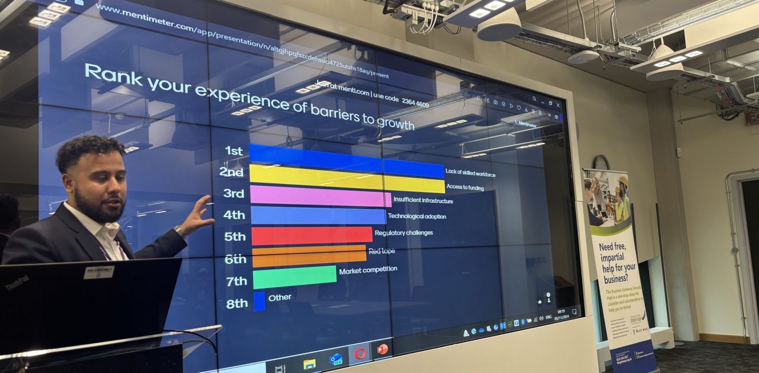 LLBSP Hosts Successful Industrial Strategy Consultation. A person standing in front of a screen showing a bar chart.